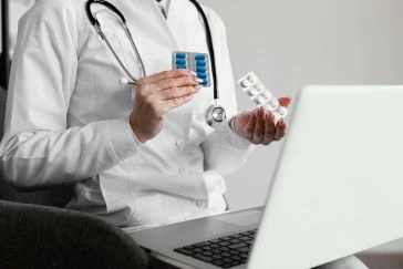 doctor with laptop and medicine